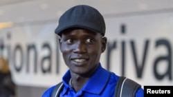 Marathon runner Guor Mading Maker (formerly Guor Marial) arrives at Heathrow Airport for the London 2012 Olympic Games, August 3, 2012. Maker's dream to run for South Sudan at the 2016 games in Rio de Janeiro suffered a blow this month when the South Sudan Athletics Federation suspended him.