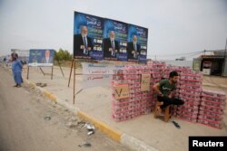 Campaign posters of a candidate are seen ahead of parliamentary elections, in Mosul, Iraq, May 3, 2018.