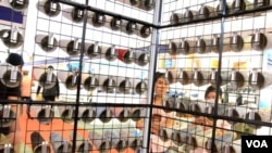 Exhibitors examine their company's yarn display at Saigon Tex, a garment and textile expo.