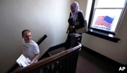 Attorney Tahirah Amatul-Wadud, who is challenging incumbent U.S. Rep. Richard Neal, D-Mass., right, leaves her campaign office with intern Michael Lachenmeyer, in Chicopee, Mass., Monday, June 18, 2018.