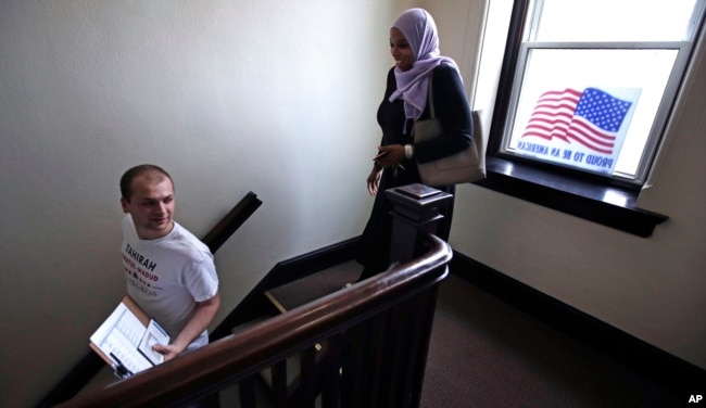 Attorney Tahirah Amatul-Wadud, who is challenging incumbent U.S. Rep. Richard Neal, D-Mass., right, leaves her campaign office with intern Michael Lachenmeyer, in Chicopee, Mass., Monday, June 18, 2018.