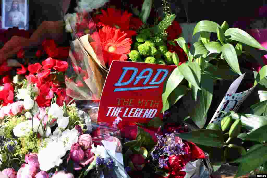 A father&#39;s day card sits among flowers left for the victims of the Grenfell apartment tower fire in North Kensington, London.