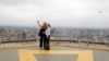 FILE - Tourists take a selfie from an observation point on the top of the Kenyatta International Convention Centre in Nairobi, Kenya, June 21, 2019. 