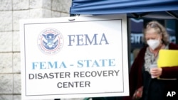 People gather at a FEMA Disaster Recovery Center at A.C. Reynolds High School in Asheville, North Carolina, Oct. 15, 2024