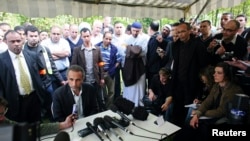 FILE - Tariq Ramadan talks to the media after a conference at the Er-Rahma mosque in Nantes, western France, Apr. 25, 2010.