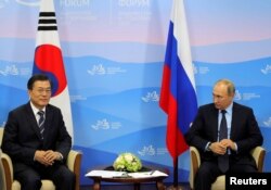 Russian President Vladimir Putin and his South Korean counterpart Moon Jae-in attend a meeting during the Eastern Economic Forum in Vladivostok, Russia, Sept. 6, 2017.