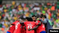 FILE - Gambia players huddle before the start of the second half of a match against Cameroon at the Stade de Japoma in Douala, Cameroon, January 29, 2022. 