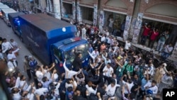 FILE - A police van carrying former law minister Anisul Huq and former Industry minister and adviser to the former Prime Minister Sheikh Hasina, Salman Fazlur Rahman, enters the court premises in Dhaka, Bangladesh, Aug. 14, 2024.