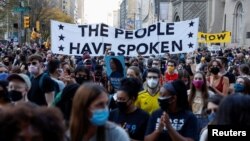 FILE - People gather as they celebrate media announcing that Democratic U.S. presidential nominee Joe Biden has won the 2020 U.S. presidential election, in Philadelphia, Pennsylvania, Nov. 7, 2020.