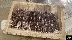 A photograph archived at the Center for Southwest Research at the University of New Mexico in Albuquerque, New Mexico, shows a group of Indigenous students who attended the Ramona Industrial School in Santa Fe. (AP Photo/Susan Montoya Bryan) 