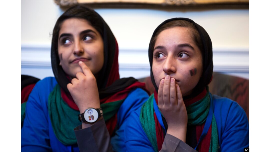 Afghanistan's FIRST Global Challenge team member Lida Azizi, left, and Fatemah Qaderyan meet with reporters following the opening ceremony in Washington, July 16, 2017.