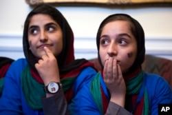 Afghanistan's FIRST Global Challenge team member Lida Azizi, left, and Fatemah Qaderyan meet with reporters following the opening ceremony in Washington, July 16, 2017.