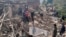 Nepalese villagers stand amidst the debris of their mudhouses after an earthquake in Doti district, Nepal, Wednesday, Nov.9, 2022.
