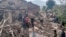 Nepalese villagers stand amidst the debris of their mudhouses after an earthquake in Doti district, Nepal, Wednesday, Nov.9, 2022. 