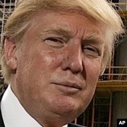 Donald Trump poses outside his Chicago offices and his 92-story residential tower underconstruction on the Chicago River in this, April 10, 2006, file photo.