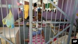 FILE - Prisoners lie in a cell in Aden Central Prison, known as Mansoura.