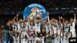 Le défenseur espagnol du Real Madrid Sergio Ramos, au milieu de ses conquiers, soulève le trophée après le sacre de son équipe en finale contre le FC Liverpool au Stade olympique de Kiev, Ukraine, 26 mai 2018.