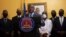 Interim Prime Minister Claude Joseph gives a press conference in Port-au-Prince, July 13, 2021. A picture of late Haitian President Jovenel Moise, who was assassinated in his home on July 7, hangs on the wall.