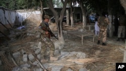 Afghan Security personnel inspect the site of a suicide attack in the Kama district of Nangarhar province, east of Kabul, Afghanistan, Oct. 2, 2018. 