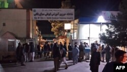 Relatives of bomb blast victims gather outside a hospital in Mazar-e-Sharif, Afghanistan, May 25, 2022.