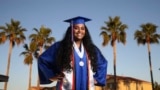 Harvard-bound Abia Khan, valedictorian of her high school class and the daughter of immigrants from Bangladesh, poses in her cap and gown in Laveen, Arizona, on May 5, 2020.