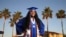 Harvard-bound Abia Khan, valedictorian of her high school class and the daughter of immigrants from Bangladesh, poses in her cap and gown in Laveen, Arizona, on May 5, 2020.