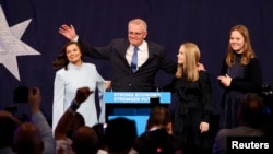 Incumbent Prime Minister Scott Morrison, leader of the Australian Liberal Party, gestures next to his wife Jenny and daughters Lily and Abbey as he addresses supporters and concedes defeat, Sydney, Australia, May 21, 2022. 