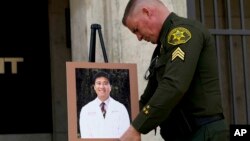 Orange County Sheriff's Sgt. Scott Steinle displays a photo of Dr. John Cheng, a 52-year-old victim who was killed in Sunday's shooting at Geneva Presbyterian Church, during a news conference in Santa Ana, Calif., Monday, May 16, 2022. (AP Photo/Jae C. Ho)