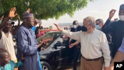 FILE - U.N. Secretary-General Antonio Guterres waves to the crowd upon his arrival in Maiduguri, Nigeria, May 3, 2022.