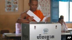 FILE - A Buddhist monk votes at a polling station in Phnom Penh, Cambodia, Sunday, July 29, 2018. With the main opposition silenced, Cambodians were voting in an election Sunday virtually certain to return to office Prime Minister Hun Sen and his party (AP Photo/Heng Sinith)