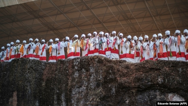FILE - Priests chant and dance during the celebration of Genna, the Ethiopian Orthodox Christmas, at Saint Mary's Church in Lalibela, Ethiopia, Jan. 7, 2022.