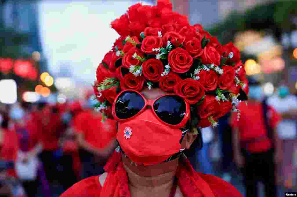 A woman attends a Red Shirt members gathering to mark the 12th anniversary of the dissolution of the 2010 rally in the city center of Bangkok, Thailand.