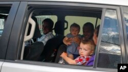 Unidentified people depart on route to the airport from the Christian Aid Ministries headquarters at Titanyen, north of Port-au-Prince, Haiti, Dec. 16, 2021.