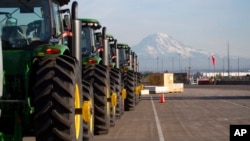 FILE - John Deere tractors are shown as they are readied for export to Asia in Tacoma, Wash., Nov. 4, 2019. U.S. President Joe Biden will unveil his administration's long-awaited Indo-Pacific Economic Framework on May 23, 2022, in Japan.