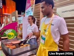 Cooing up veggie burgers and hotdogs, Paris, France, May 19, 2022.