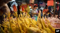 A seller prepares freshly butchered chickens at the Kampung Baru wet market in Kuala Lumpur, Malaysia, Tuesday, May 31, 2022.