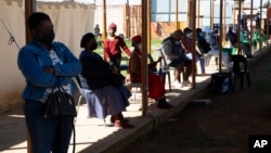 People queue at a COVID-19 testing center in Soweto, South Africa, May 11, 2022.