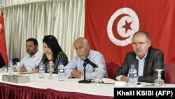 FILE: Noureddine Taboubi (R), Secretary-General of the Tunisian General Labour Union (UGTT), chairs the meeting of the body's national administrative commission in Hammamet on May 23, 2022. 