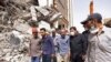In this photo released by official website of the office of Iranian Senior Vice-President, on May 27, 2022, Vice-President Mohammad Mokhber, second right, visits the site of a tower at under construction 10-story Metropol Building which collapsed in the s
