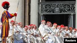 FILE - Cardinals attend mass in St. Peter's Square at the Vatican, May 15, 2022. Pope Francis named 21 new cardinals Sunday.