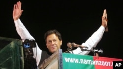 FILE - Former Pakistani Prime Minister Imran Khanm is seen during an anti-government rally, in Lahore, Pakistan, April 21, 2022. Khan called May 22, 2022, for his supporters to march peacefully on Islamabad on May 25, to press for fresh elections. 