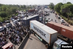 Vehicles are parked to block the roads, ahead of a planned protest march toward Islamabad led by ousted Prime Minister Imran Khan, in Lahore, Pakistan, May 24, 2022.