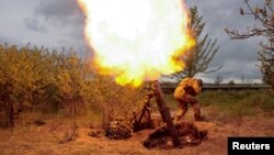A Ukrainian serviceman fires with a mortar at a position, as Russia's attack on Ukraine continues, at an unknown location in Kharkiv region, Ukraine May 9, 2022. 