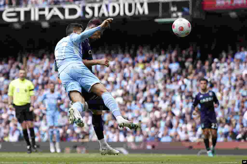 Manchester City&#39;s Joao Cancelo, left, fails to stop Aston Villa&#39;s Matty Cash from scoring his sides first goal during the English Premier League soccer match between Manchester City and Aston Villa at the Etihad Stadium in Manchester, England.