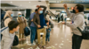 US dollar bills shower Afghan refugee Najeebullah and his family as they arrive at the Seattle International Airport. (Photo by Joshua Trujillo)