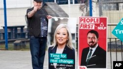 A man gives the thumbs up as he arrives at a polling station in West Belfast, Northern Ireland, May 5, 2022.