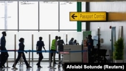 FILE: Security officers are seen at the passport control point at the Nnamdi Azikiwe international airport in Abuja, Nigeria. Taken Sept. 7, 2020. 