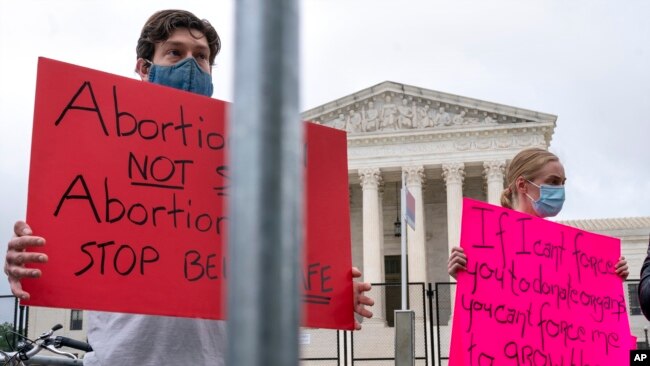 People protest in support of abortion rights while visiting Washington, May 13, 2022, outside the Supreme Court, and ahead of expected abortion rights rallies across the country on Saturday.