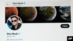 FILE - Part of Elon Musk's Twitter page is seen on a screen of a computer in Sausalito, California, April 25, 2022.
