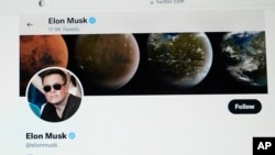 FILE - Part of Elon Musk's Twitter page is seen on a screen of a computer in Sausalito, California, April 25, 2022.